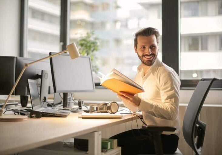 lawyer holding book at computer for ethic advertising site lawyer holding book at computer for ethic advertising site