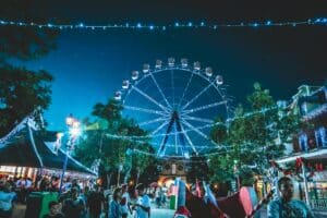 ferris wheel amusement park or fair image with people in front at night ethic advertising agency