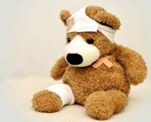 brown and white bandaged teddy bear